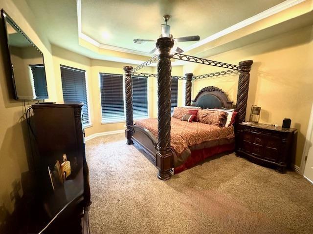 9265 N Sage, Beaumont, TX 77713 - carpeted bedroom featuring crown molding, ceiling fan, and a tray ceiling
