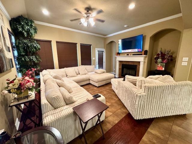 9265 N Sage, Beaumont, TX 77713 - living area with a ceiling fan, a fireplace, ornamental molding, tile patterned floors, and recessed lighting