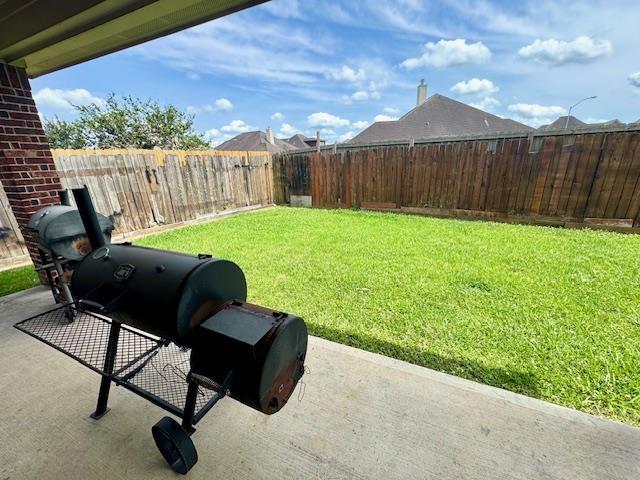 9265 N Sage, Beaumont, TX 77713 - fenced backyard with a patio area
