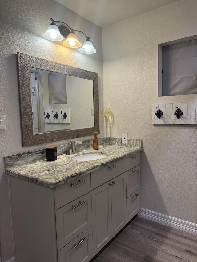 2211 Summer Oak Ln, Orange, TX 77632 - bathroom with vanity, wood finished floors, and a textured wall