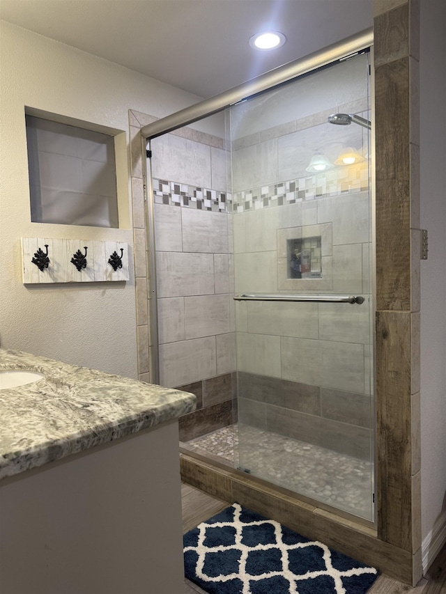 2211 Summer Oak Ln, Orange, TX 77632 - full bath featuring vanity, a shower stall, and wood finished floors