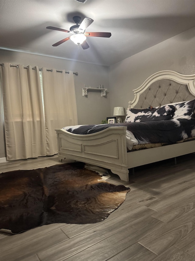 2211 Summer Oak Ln, Orange, TX 77632 - bedroom with wood finished floors and a ceiling fan