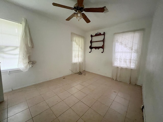 unfurnished room with ceiling fan and light tile patterned floors