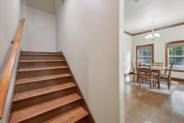 1291 Beachrock Dr, Brookeland, TX 75931 - staircase featuring a chandelier, concrete floors, and ornamental molding