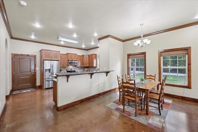 1291 Beachrock Dr, Brookeland, TX 75931 - dining area featuring finished concrete floors, crown molding, a chandelier, and recessed lighting