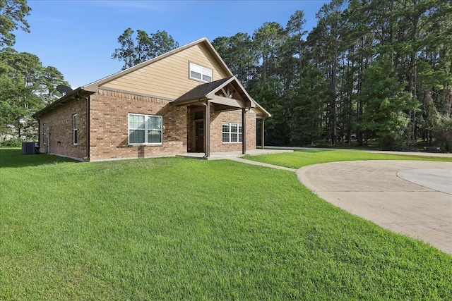 1291 Beachrock Dr, Brookeland, TX 75931 - view of front of home with brick siding and a front yard