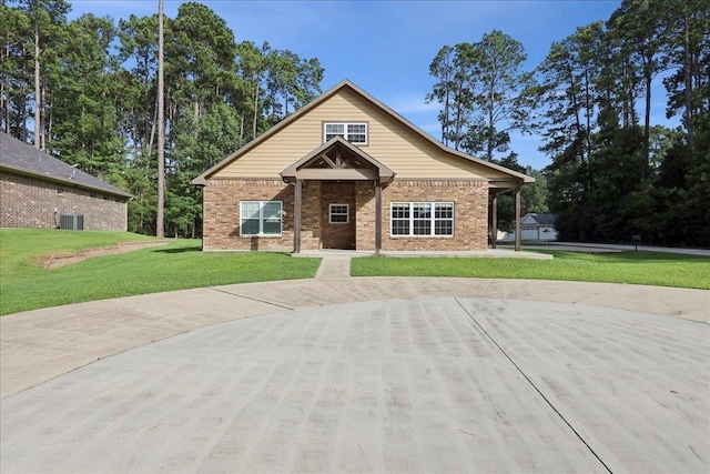 1291 Beachrock Dr, Brookeland, TX 75931 - view of front facade featuring a front yard and brick siding