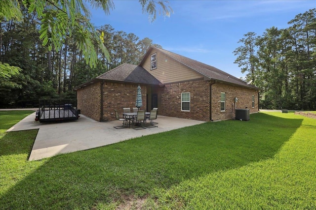 1291 Beachrock Dr, Brookeland, TX 75931 - rear view of house featuring a patio area, a yard, and brick siding