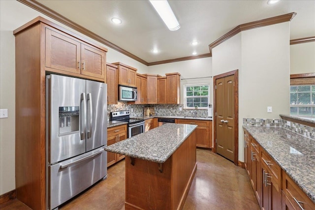 1291 Beachrock Dr, Brookeland, TX 75931 - kitchen with stainless steel appliances, ornamental molding, decorative backsplash, brown cabinets, and recessed lighting