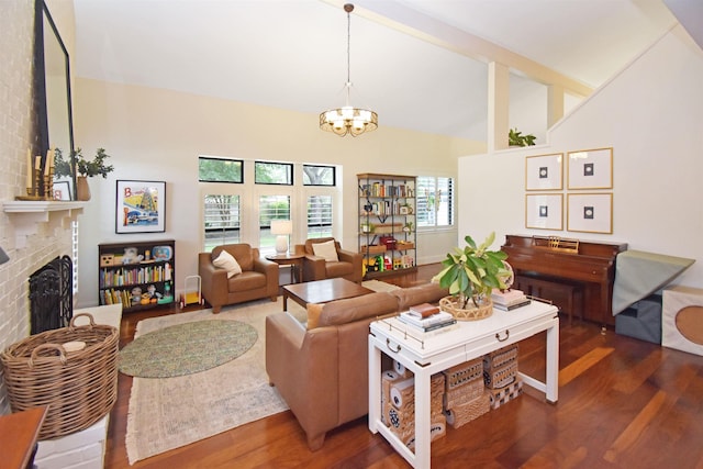 4795 Chadwick Dr, Beaumont, TX 77706 - living room featuring high vaulted ceiling, wood finished floors, a chandelier, and a fireplace