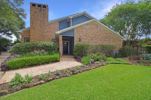 4795 Chadwick Dr, Beaumont, TX 77706 - view of front of house with brick siding and a chimney