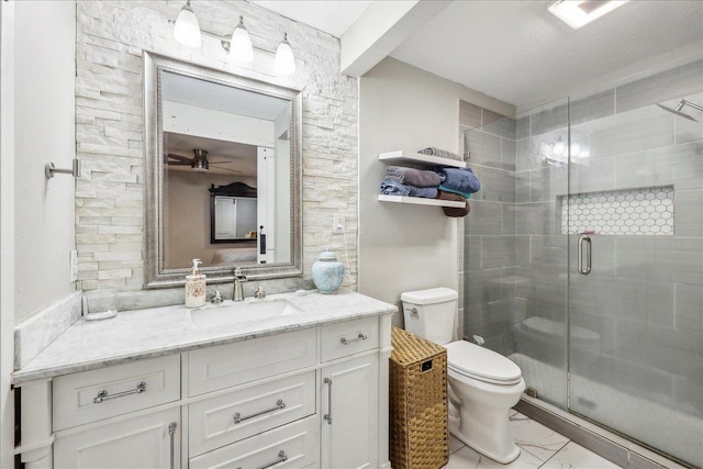 5938 W Madison Blvd, Groves, TX 77619 - full bath with toilet, vanity, marble look tiles, a stall shower, and a ceiling fan