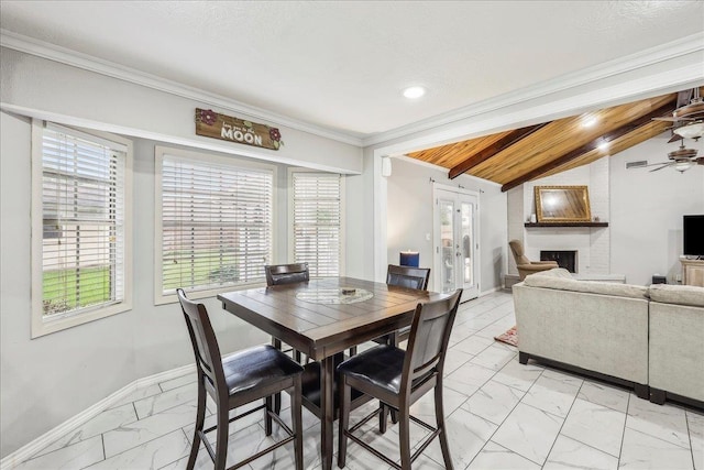 5938 W Madison Blvd, Groves, TX 77619 - dining space featuring light marble finish floors, baseboards, a fireplace, ceiling fan, and crown molding