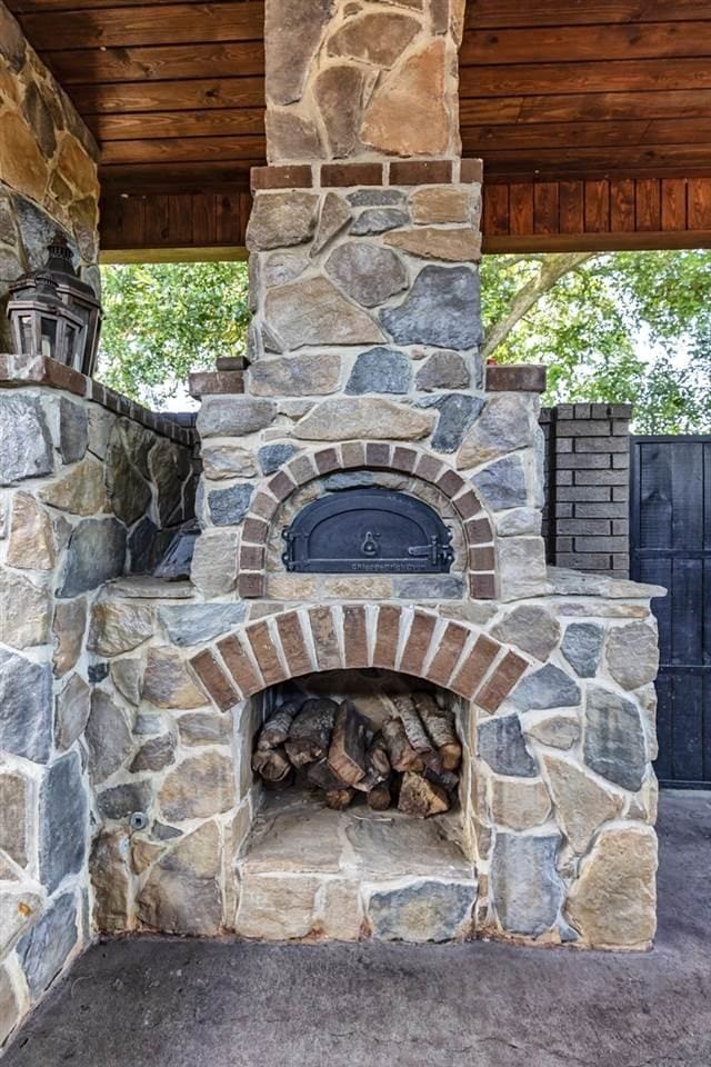 exterior details with an outdoor stone fireplace