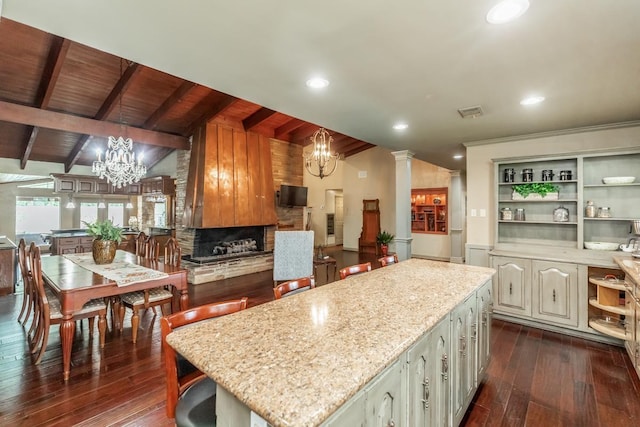 kitchen featuring wooden ceiling, dark wood-type flooring, lofted ceiling with beams, hanging light fixtures, and a kitchen island