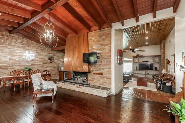 living area featuring hardwood / wood-style floors, high vaulted ceiling, ceiling fan with notable chandelier, a stone fireplace, and beam ceiling