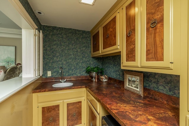 kitchen featuring ornamental molding and sink