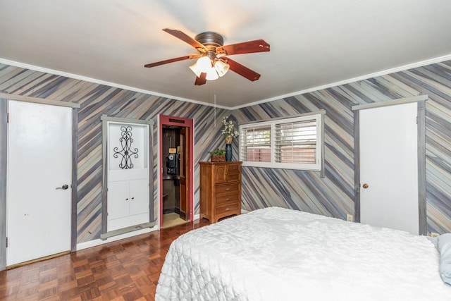 bedroom featuring dark parquet floors, ceiling fan, and ornamental molding