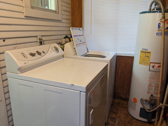 clothes washing area with washing machine and clothes dryer and water heater