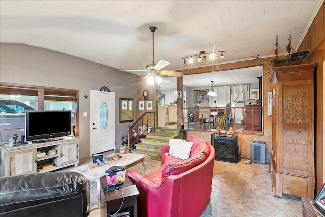 living room featuring ceiling fan and vaulted ceiling