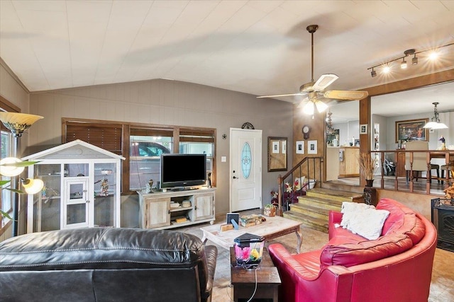 living room with ceiling fan and lofted ceiling