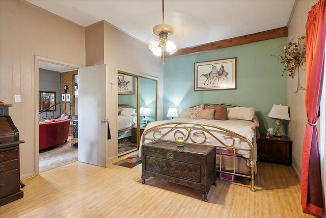 bedroom with a closet, ceiling fan, and light hardwood / wood-style floors