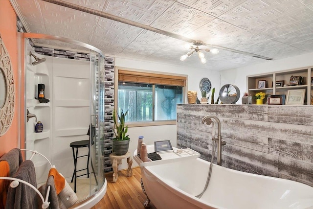 bathroom with hardwood / wood-style floors and a bathtub