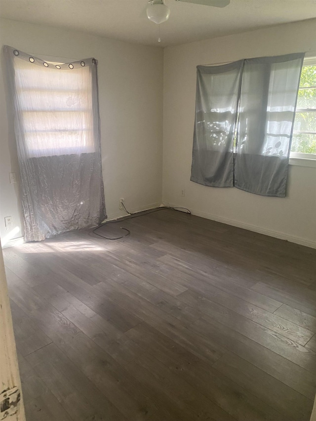 unfurnished room with ceiling fan and dark hardwood / wood-style floors