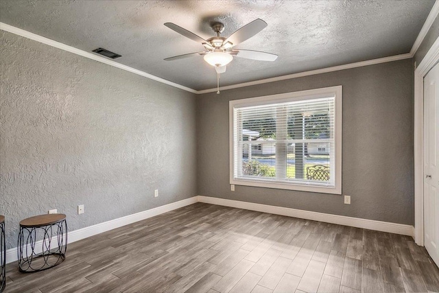 unfurnished room featuring ceiling fan, crown molding, a textured ceiling, and hardwood / wood-style flooring