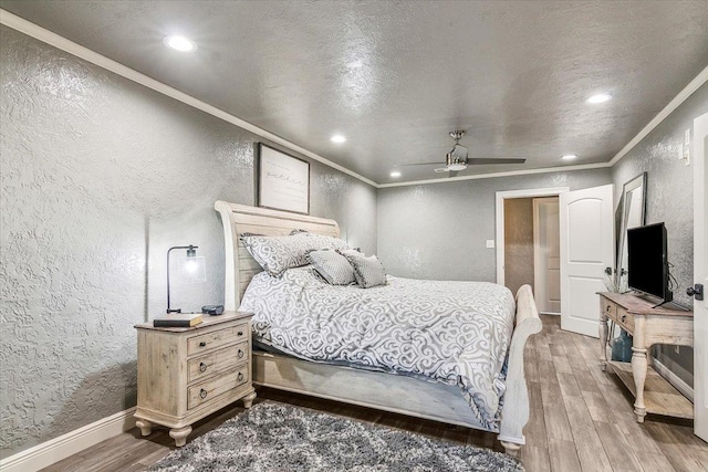 bedroom featuring hardwood / wood-style flooring, ceiling fan, and ornamental molding