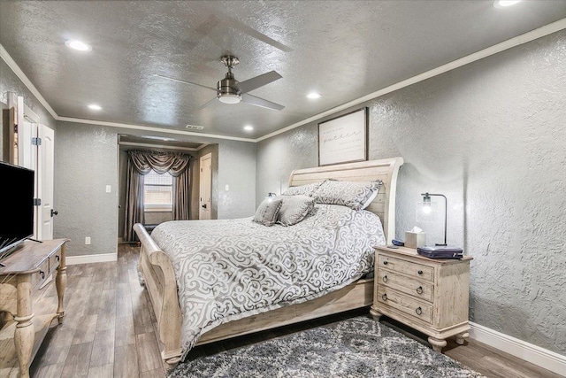 bedroom featuring ceiling fan, dark hardwood / wood-style flooring, and crown molding