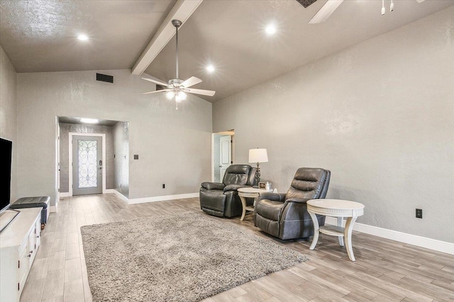 sitting room with beam ceiling, high vaulted ceiling, and light hardwood / wood-style floors