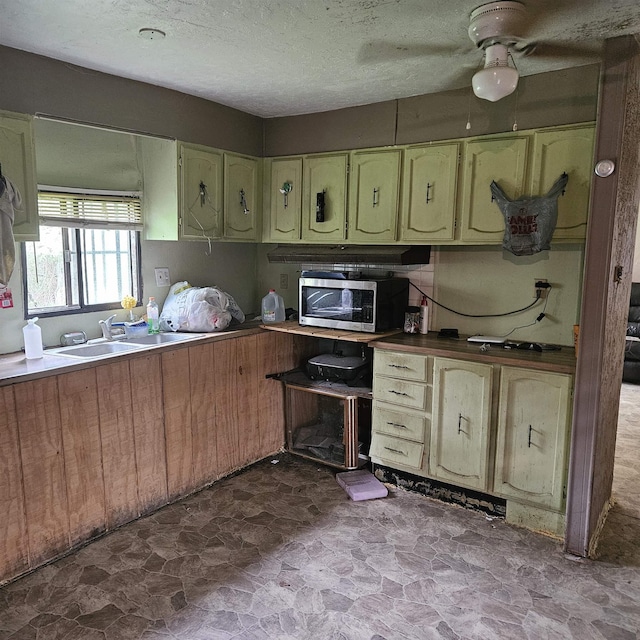 kitchen with sink and a textured ceiling