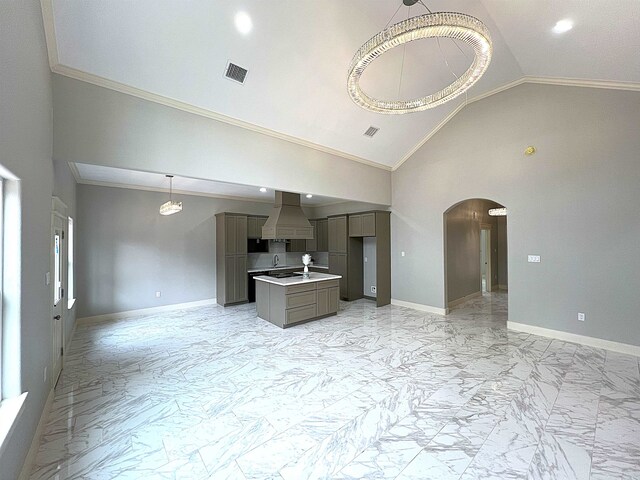 kitchen with decorative backsplash, island range hood, gray cabinetry, and ornamental molding