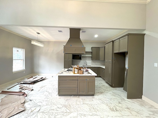 kitchen with decorative light fixtures, gray cabinets, sink, island exhaust hood, and ornamental molding