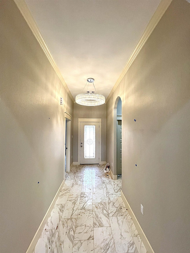 doorway with an inviting chandelier and crown molding