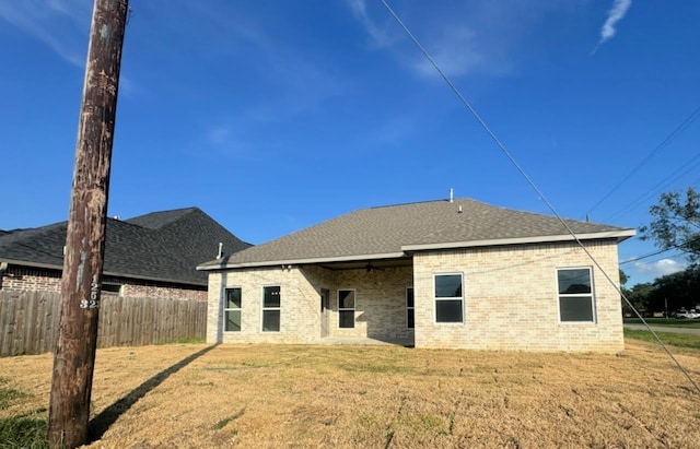 rear view of house featuring a yard