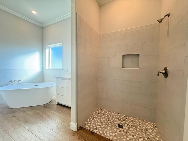 bathroom featuring ornamental molding, shower with separate bathtub, vanity, tile walls, and hardwood / wood-style flooring