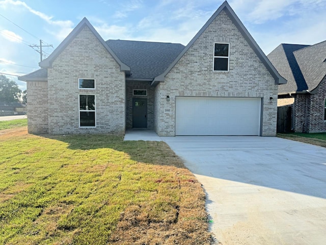 view of front of home with a garage and a front lawn