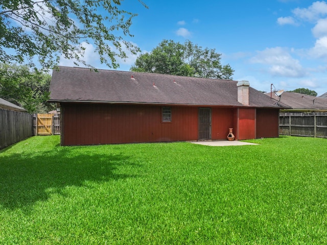 1940 Sams Way, Beaumont, TX 77706 - back of house with a fenced backyard, a patio, and a chimney