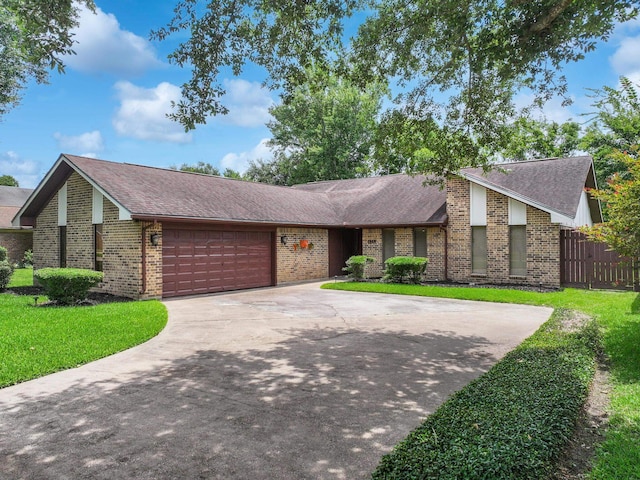 1940 Sams Way, Beaumont, TX 77706 - mid-century home with an attached garage, brick siding, roof with shingles, and concrete driveway