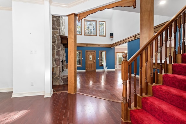 entryway featuring hardwood / wood-style floors, a stone fireplace, and a healthy amount of sunlight