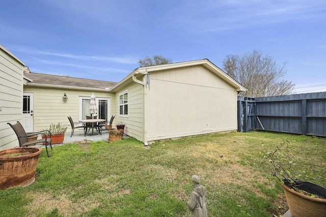 rear view of house with a yard and a patio area