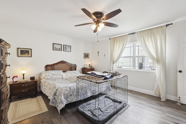 bedroom with ceiling fan and light hardwood / wood-style flooring