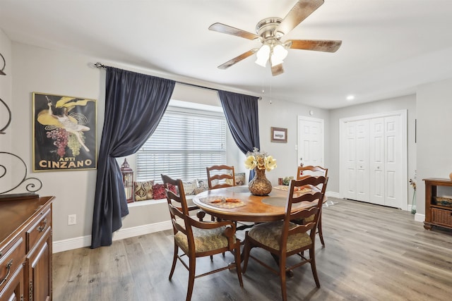 dining space with ceiling fan and hardwood / wood-style floors