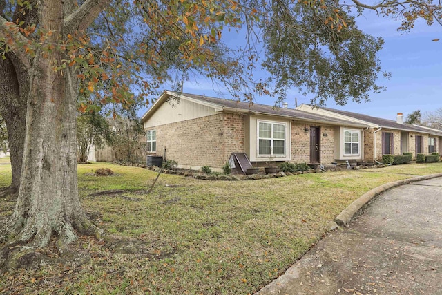 exterior space with central AC unit and a front yard