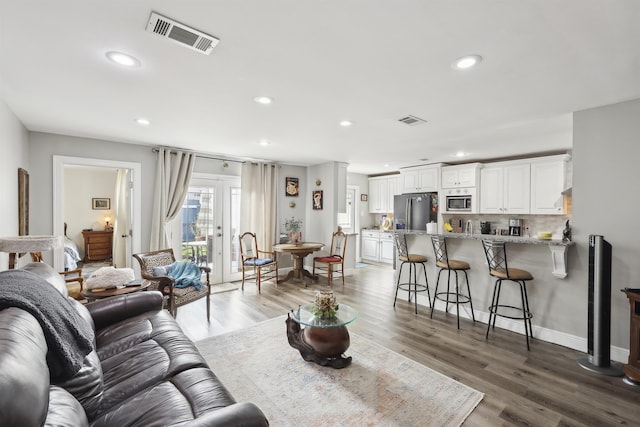 living room with wood-type flooring and french doors