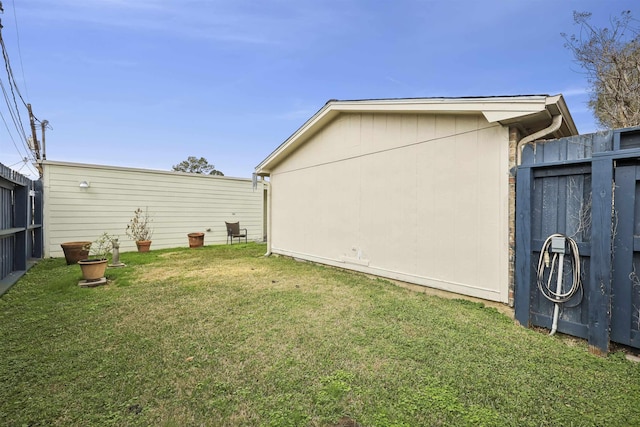 view of side of home with a lawn