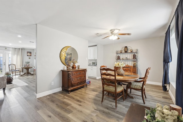 dining room with hardwood / wood-style floors and ceiling fan