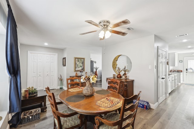 dining area featuring light hardwood / wood-style floors and ceiling fan